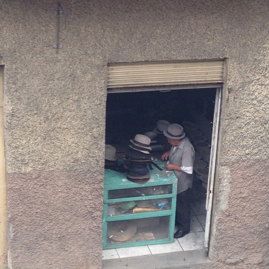 A man repairs Panama hats in his tiny shop.
